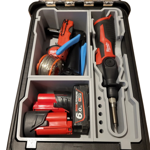 Tool kit with cordless drill, battery, and accessories inside a black and gray case.