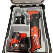 Milwaukee tool set with drill and battery in a clear case on a white background