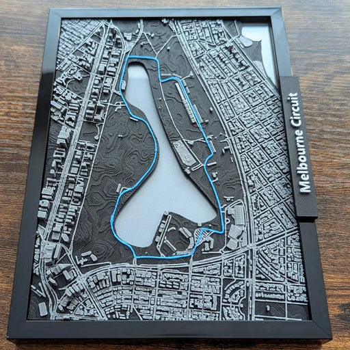 3D model of a race track layout on a wooden surface