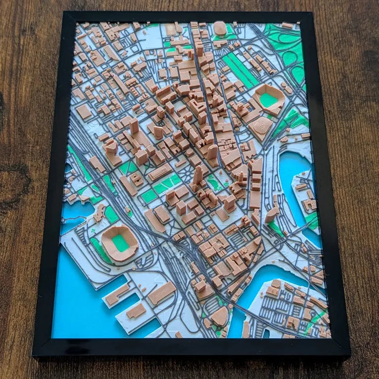 Framed 3D city map on a wooden surface
