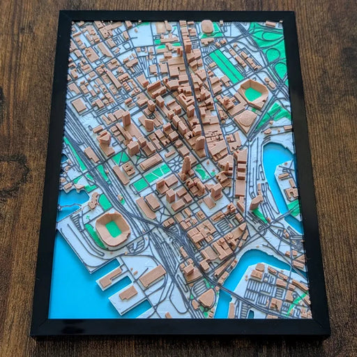 Framed 3D city map on a wooden surface