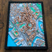 Framed 3D city map on a wooden surface