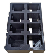 Black foam packaging tray with compartments on a wooden surface