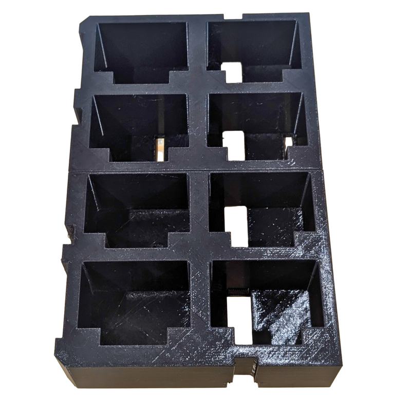A black plastic battery holder insert designed for the Milwaukee PACKOUT 2-Drawer System, capable of holding 8 M18 batteries.