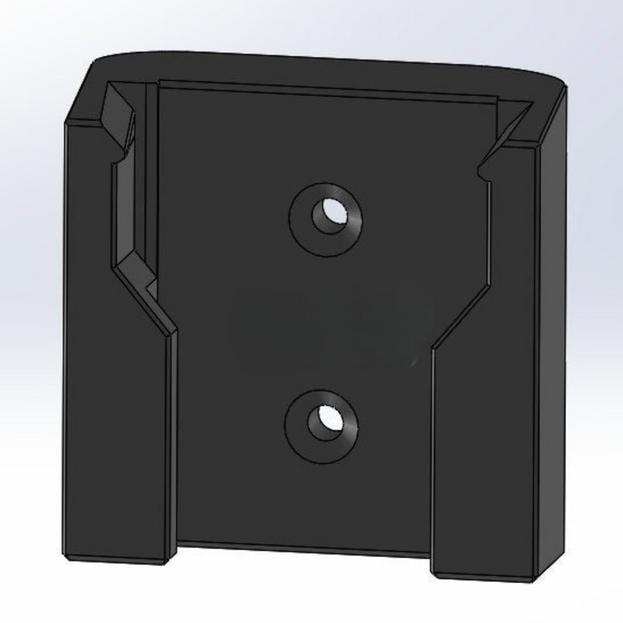Black rectangular object with two circular holes on a light gray background