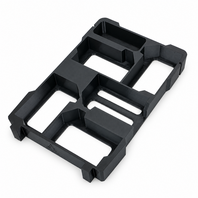 Black five-slot M18 battery holder insert with accessory tray on white background, angled view
