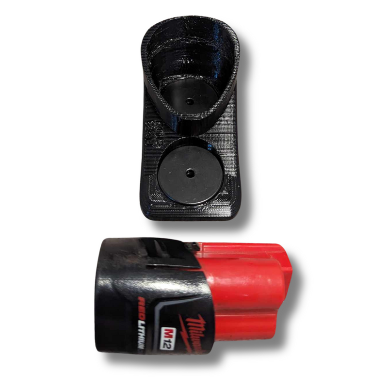 Milwaukee M12 battery held to a steel surface by the soft magnetic TPU base cover