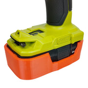 Orange magnetic battery case for Ryobi ONE+ 18V, case fitted around a drill battery.