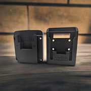 Two black Ozito 18V tool and battery holders, designed to be mounted on a wall or toolbox, with the brand name 'Ozito' visible on the front.