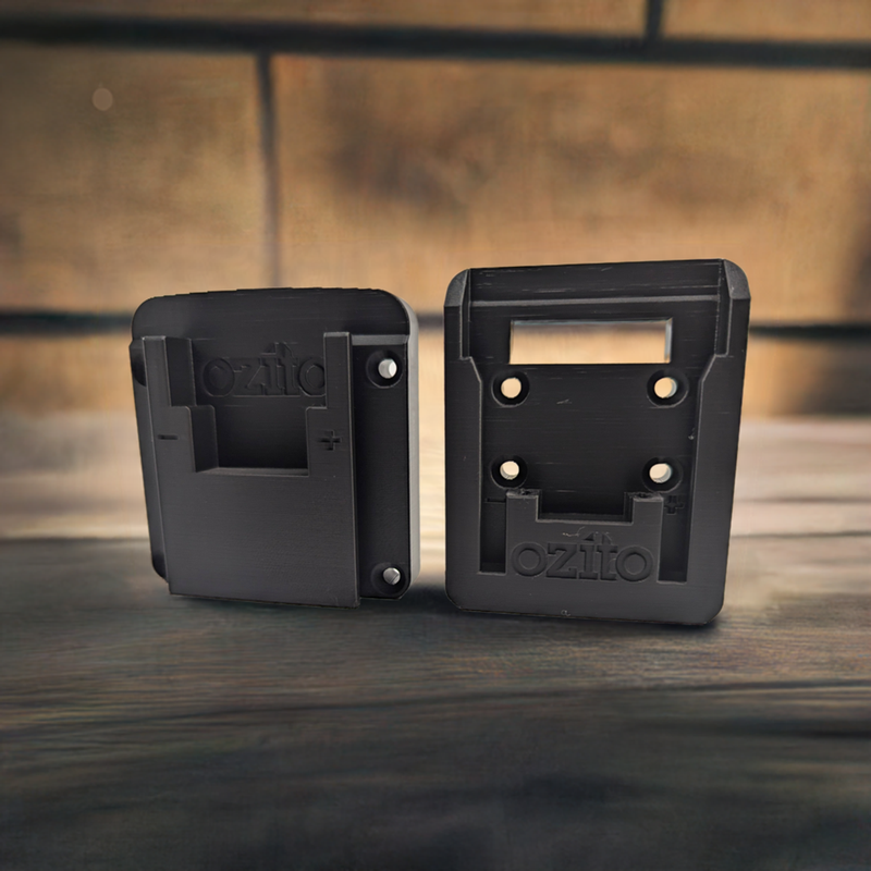 Two black Ozito 18V tool and battery holders, designed to be mounted on a wall or toolbox, with the brand name 'Ozito' visible on the front.