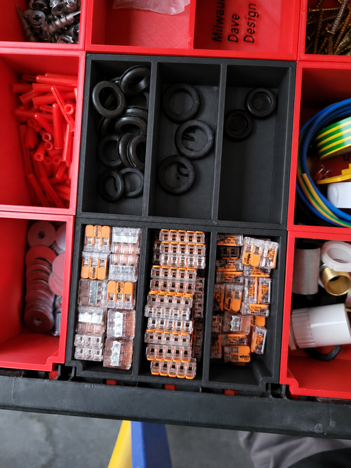 Centre six-compartment Packout drawer insert in black, shown with contents for demonstration