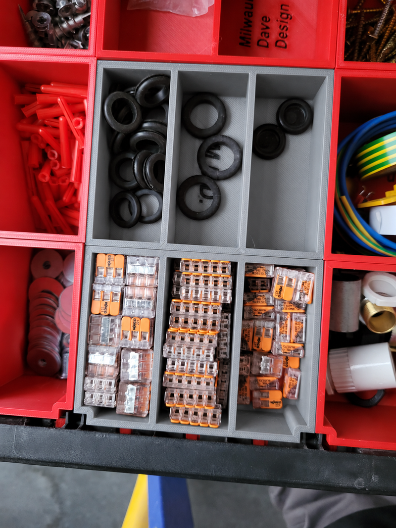 Centre six-compartment Packout drawer insert in gray, shown with contents for demonstration
