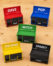 Several personalised mini tool chests in different colours, each with a custom name