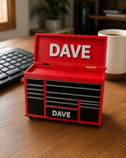 Red personalised mini tool chest sitting on a desk, custom name printed on the lid